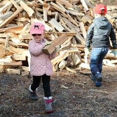 Children volunteers carry wood clean up day