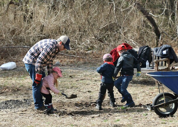 Family volunteers homesite clean up day