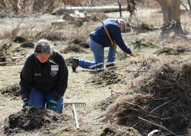 Trsutee volunteers hoemsite clean up day
