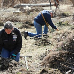 Trsutee volunteers hoemsite clean up day