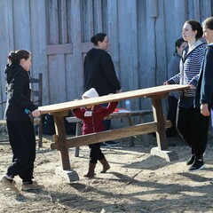 Volunteers carry bench fort clean up day