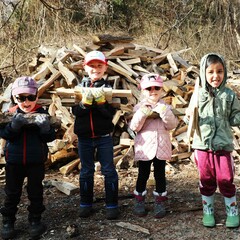 Young volunteers homesite stacking wood clean up day