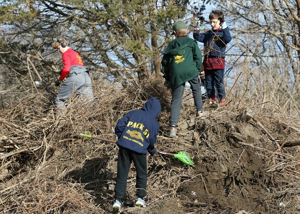 Young volunteers yard work clean up day
