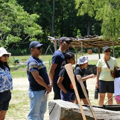 Guests gather in front of the Mishoon on the Historic Patuxet Homesite