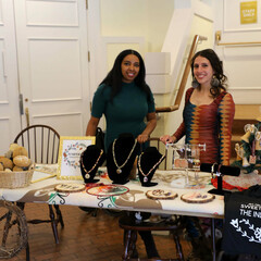The founders of Juniper and Pine Collective stand behind their table featuring handmade items at the Winter Fine Arts & Craft Fair.