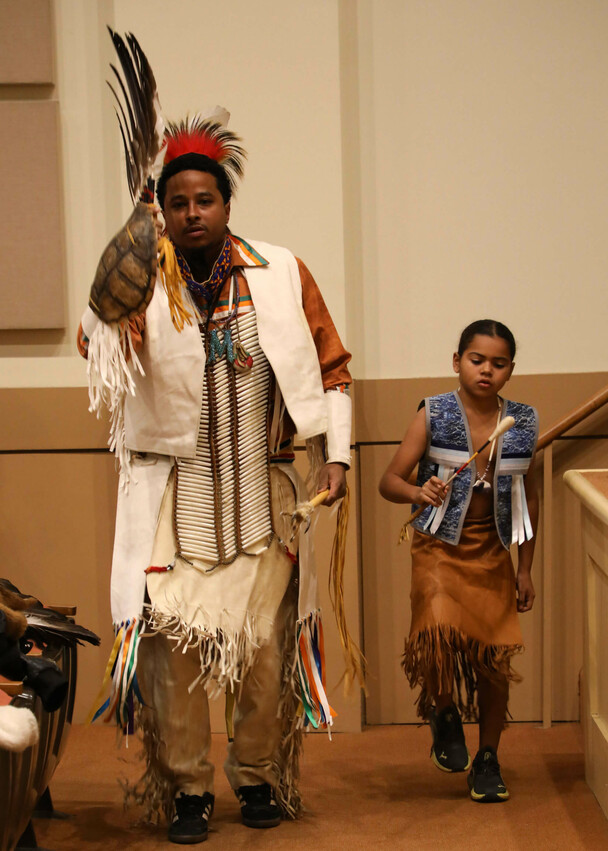 An adult and child member of Wetu Ways demonstrate a traditional dance in Plimoth Cinema.